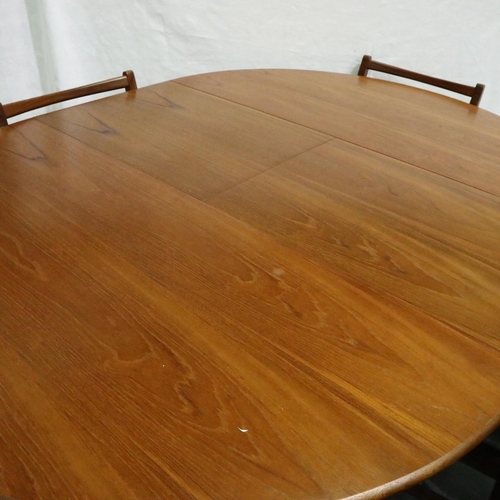 3122 - A Younger? mid 20th century Danish teak extending dining table with metamorphic leaf and a set of fo... 