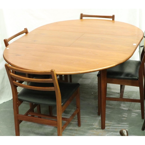 3122 - A Younger? mid 20th century Danish teak extending dining table with metamorphic leaf and a set of fo... 