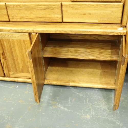 3125 - Substantial oak sideboard with four cupboards, having a three-drawer top-section with display shelve... 