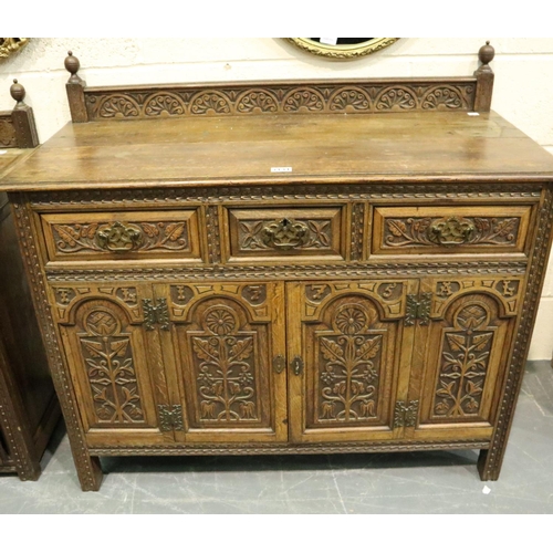 3131 - Early 20th century oak cabinet, heavily carved in the Jacobean manner, having three short drawers an... 