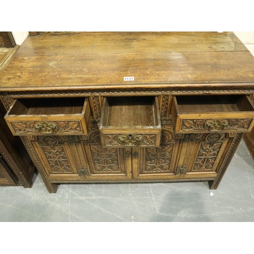 3131 - Early 20th century oak cabinet, heavily carved in the Jacobean manner, having three short drawers an... 