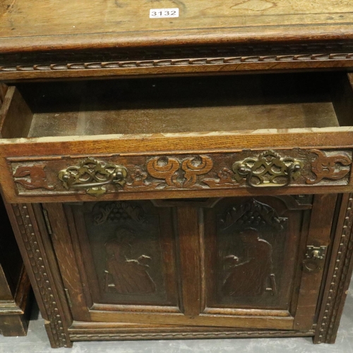 3132 - Early 20th century oak cabinet, heavily carved in the Jacobean manner, having a single cupboard door... 