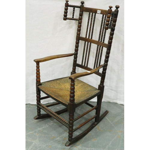 3133 - 19th century Dutch elm bobbin-form rocking chair with extended wings and rushed seat. Not available ... 