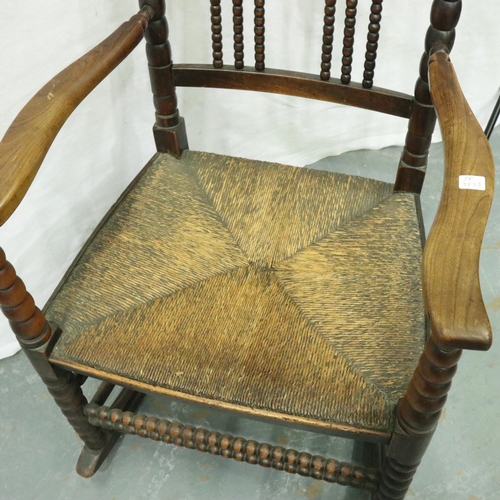 3133 - 19th century Dutch elm bobbin-form rocking chair with extended wings and rushed seat. Not available ... 