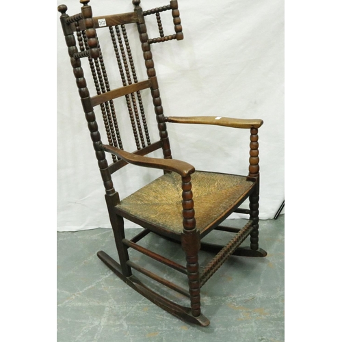 3133 - 19th century Dutch elm bobbin-form rocking chair with extended wings and rushed seat. Not available ... 