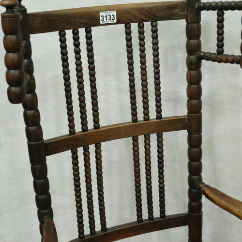 3133 - 19th century Dutch elm bobbin-form rocking chair with extended wings and rushed seat. Not available ... 