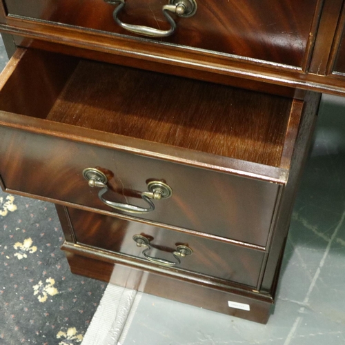 3105 - Reproduction mahogany twin pedestal writing desk having eight drawers and tooled green leather inset... 