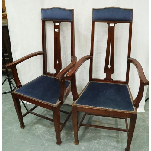 3128 - A pair of oak framed Arts and Crafts period elbow chairs, each with upholstered seat and headrest, e... 