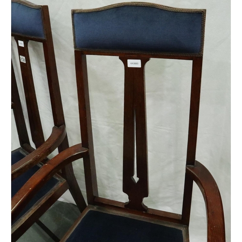 3128 - A pair of oak framed Arts and Crafts period elbow chairs, each with upholstered seat and headrest, e... 