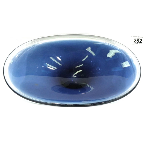 282 - A large Wedgwood blue glass centre bowl, L: 38 cm. No colour loss/fading, minor scratches to base, o... 