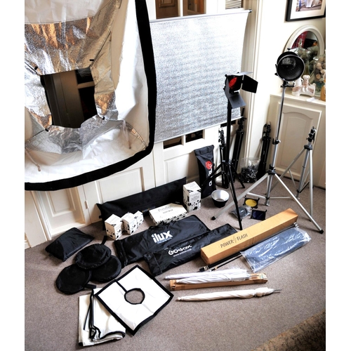 293 - A large quantity of studio lighting equipment to include lights, tripods, reflectors, umbrellas etc.... 