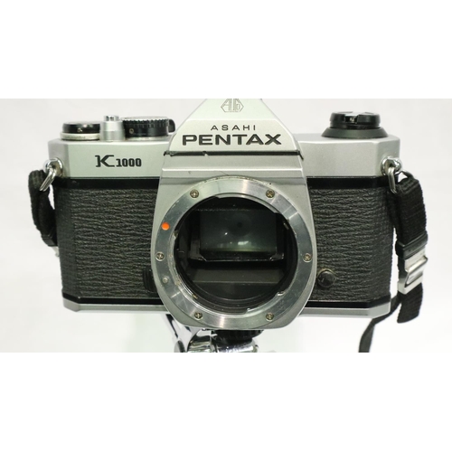 301 - Pentax K1000 camera with 50mm 1:2 lens, 28mm 1:2.8 lens, tripod, case and camera bag.  Camera winder... 