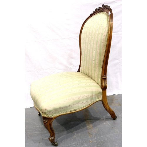 3112 - A Victorian walnut framed parlour chair with upholstered seat and backrest, low seated and brass cas... 