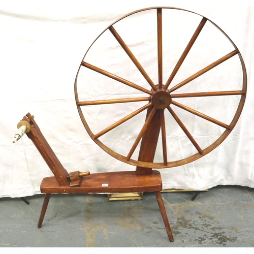 3116 - A late 20th century spinning wheel in pine with pegged joints and raised on three supports, overall ... 