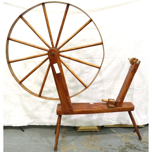 3116 - A late 20th century spinning wheel in pine with pegged joints and raised on three supports, overall ... 