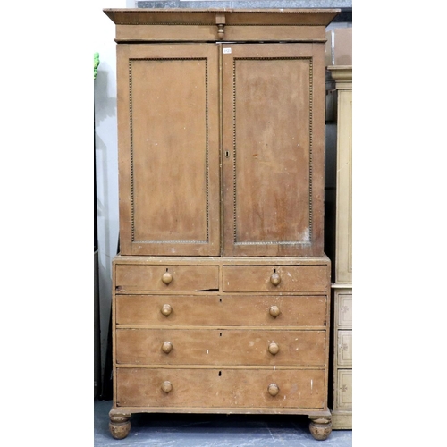 3123 - A Victorian pine linen press with a chest base of two short above three long drawers, the cupboard f... 