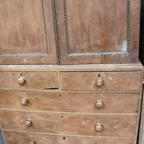 3123 - A Victorian pine linen press with a chest base of two short above three long drawers, the cupboard f... 