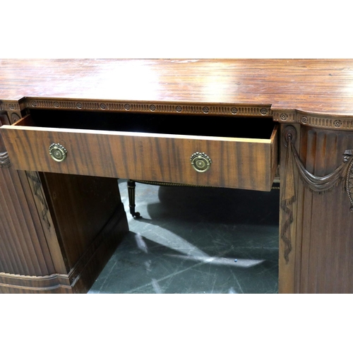 3138 - A regency period twin pedestal sideboard, having a single drawer flanked by carved and gadrooned cup... 