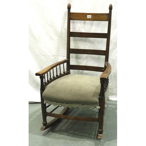 3163 - An Arts and Crafts period elm rocking chair with laddered back and spindled supports. Not available ... 