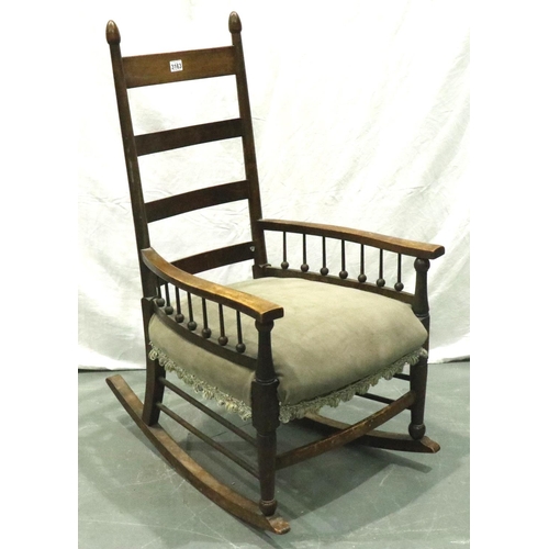 3163 - An Arts and Crafts period elm rocking chair with laddered back and spindled supports. Not available ... 