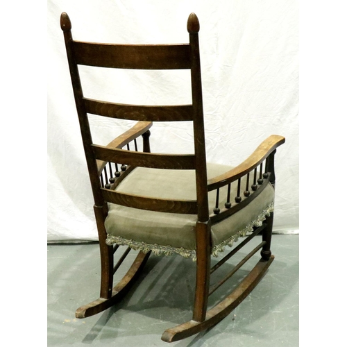 3163 - An Arts and Crafts period elm rocking chair with laddered back and spindled supports. Not available ... 