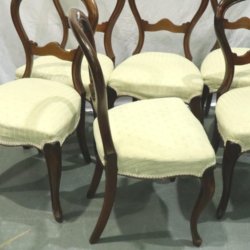 3165 - A set of six Victorian walnut balloon-back dining chairs with later upholstered seats. Not available... 