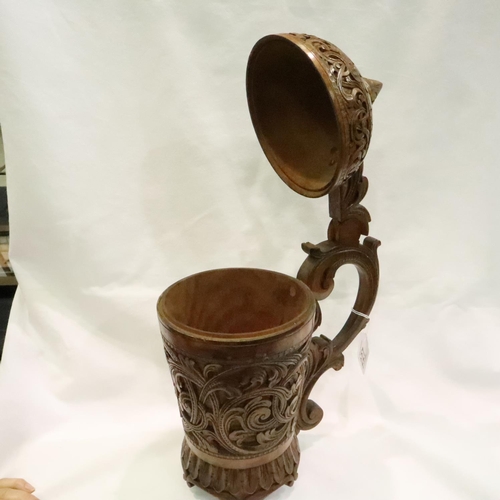 227 - 19th century large heavily carved, walnut lidded stein, H: 34 cm. Crack from below handle to the cen... 