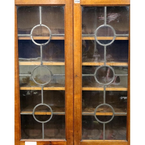 3104 - An Arts and Crafts walnut wall mounting bookcase, two door with leaded glass and four adjustable she... 