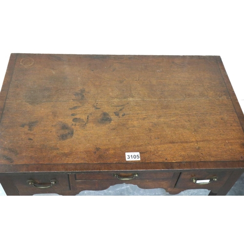 3105 - George II oak lowboy, crossbanded and inlaid with ebony, having three short drawers and shaped friez... 