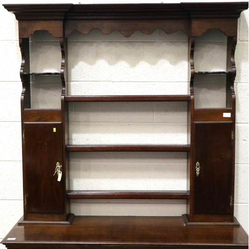 3106 - An 18th century oak dresser, the open plate rack with two cupboards sits on a base of two short draw... 