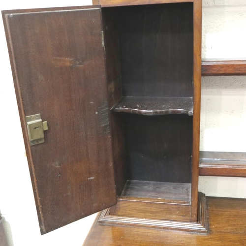 3106 - An 18th century oak dresser, the open plate rack with two cupboards sits on a base of two short draw... 