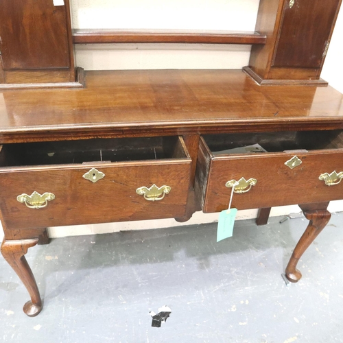 3106 - An 18th century oak dresser, the open plate rack with two cupboards sits on a base of two short draw... 