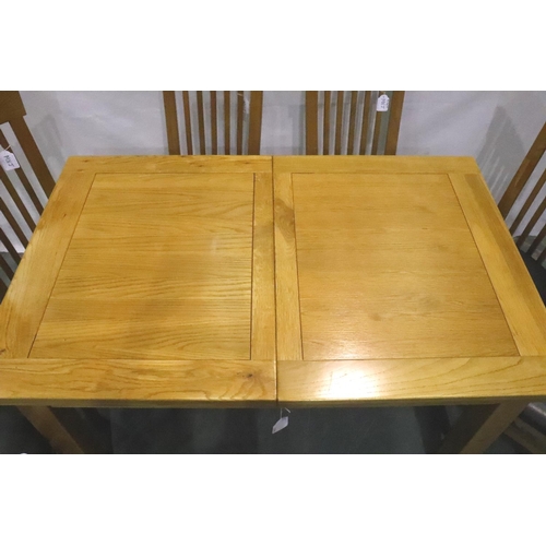 3133 - JTW solid golden oak table, extending with integral leaf and six matching chairs with makers stamp, ... 