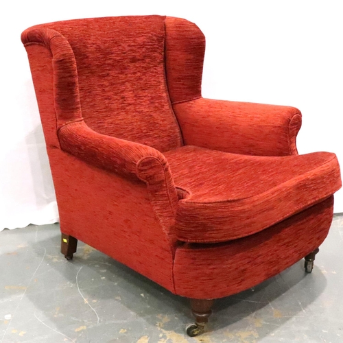 3134 - A late 19th century upholstered wing back easy chair, low seated and raised on castors, H: 86 cm. No... 