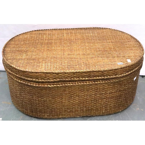 3140 - A large canework hamper of oval form, with hinged rigid lid, 110 x 71 x 45 cm H. Not available for i... 