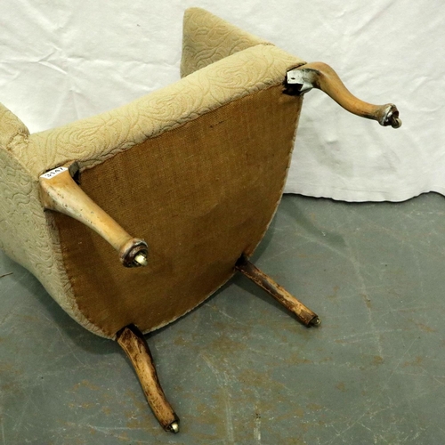 3147 - An unusual early 20th century tub chair with high back of tapering form, raised on walnut supports, ... 