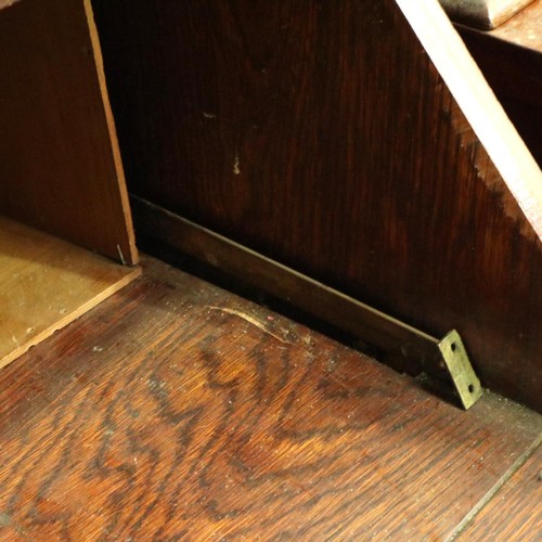 3154 - A late 19th century oak bureau bookcase, having two leaded glazed doors above a fitted interior and ... 