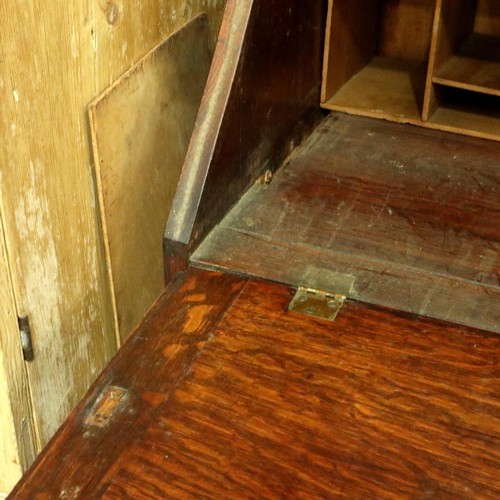 3154 - A late 19th century oak bureau bookcase, having two leaded glazed doors above a fitted interior and ... 