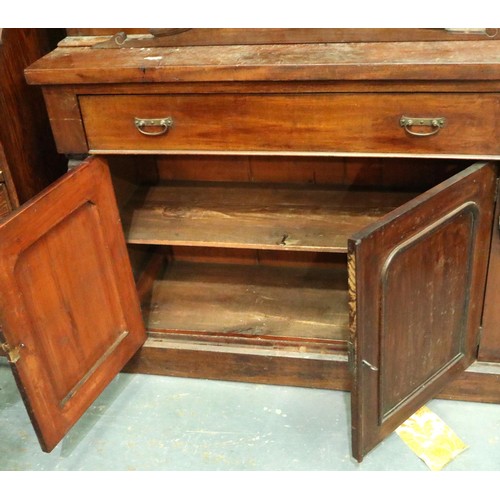 3155 - A Victorian bookcase, having two doors glazed with stained glass, three shelves raised above a sideb... 