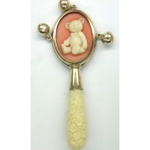 123 - Modern sterling silver rattle, set with teddy cameo and teething stick, L: 80 mm, boxed. P&P Group 1... 