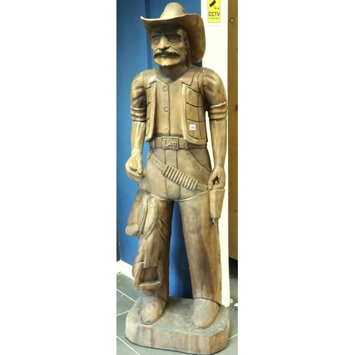 388 - Large carved wood cowboy figure with Lee belt buckle, H: 180 cm. Two cracks to hat, small crack wher... 