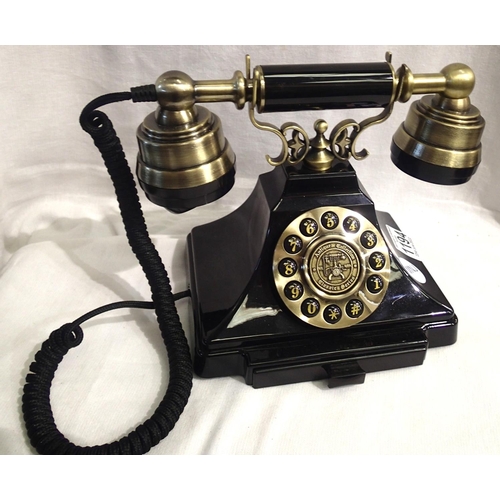 1194 - The Duke is a 1920s style push button telephone with a black & brass finish and traditional cloth ha... 