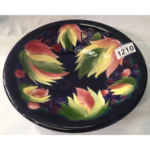 1210 - Moorcroft blue ground large footed bowl in the Berries and Leaves pattern, D: 25 cm. Has been in two... 