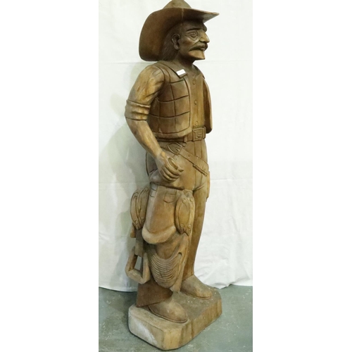 388 - Large carved wood cowboy figure with Lee belt buckle, H: 180 cm. Two cracks to hat, small crack wher... 