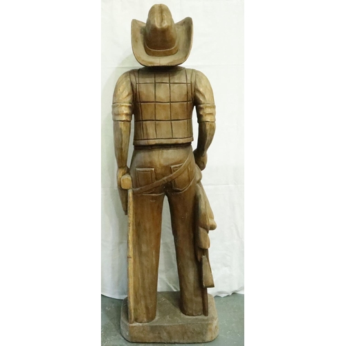 388 - Large carved wood cowboy figure with Lee belt buckle, H: 180 cm. Two cracks to hat, small crack wher... 