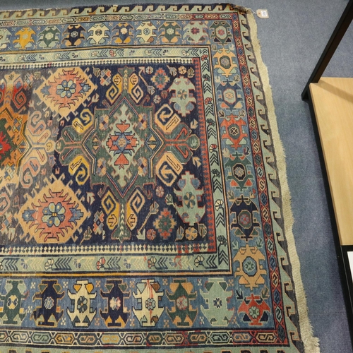 3097 - A large Sumak Kelim knotted rug, having geometric designs against a blue ground, 280 x 160 cm. No vi... 