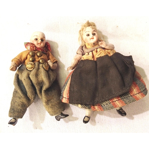 2173 - Miniature ceramic dolls, man and woman, with jointed arms and legs, appear in original clothing, app... 