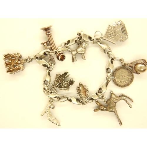 29 - 925 silver charm bracelet with ten charms, L: 15 cm, combined 42g. P&P Group 1 (£14+VAT for the firs... 