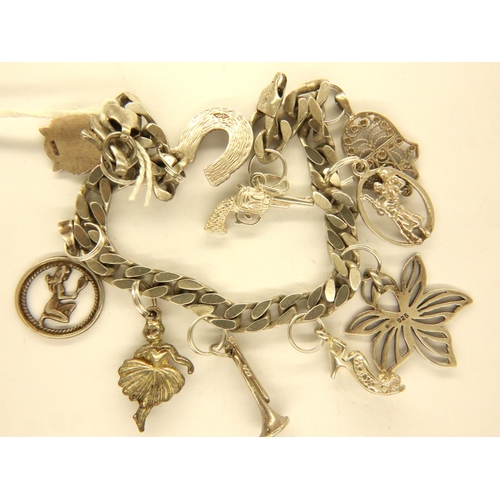 52 - 925 silver charm bracelet with ten charms, L: 20 cm, combined 35g. P&P Group 1 (£14+VAT for the firs... 