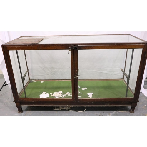 3056 - An early 20th century glazed shop display counter with hinged doors, lacking shelves, counter top gl... 